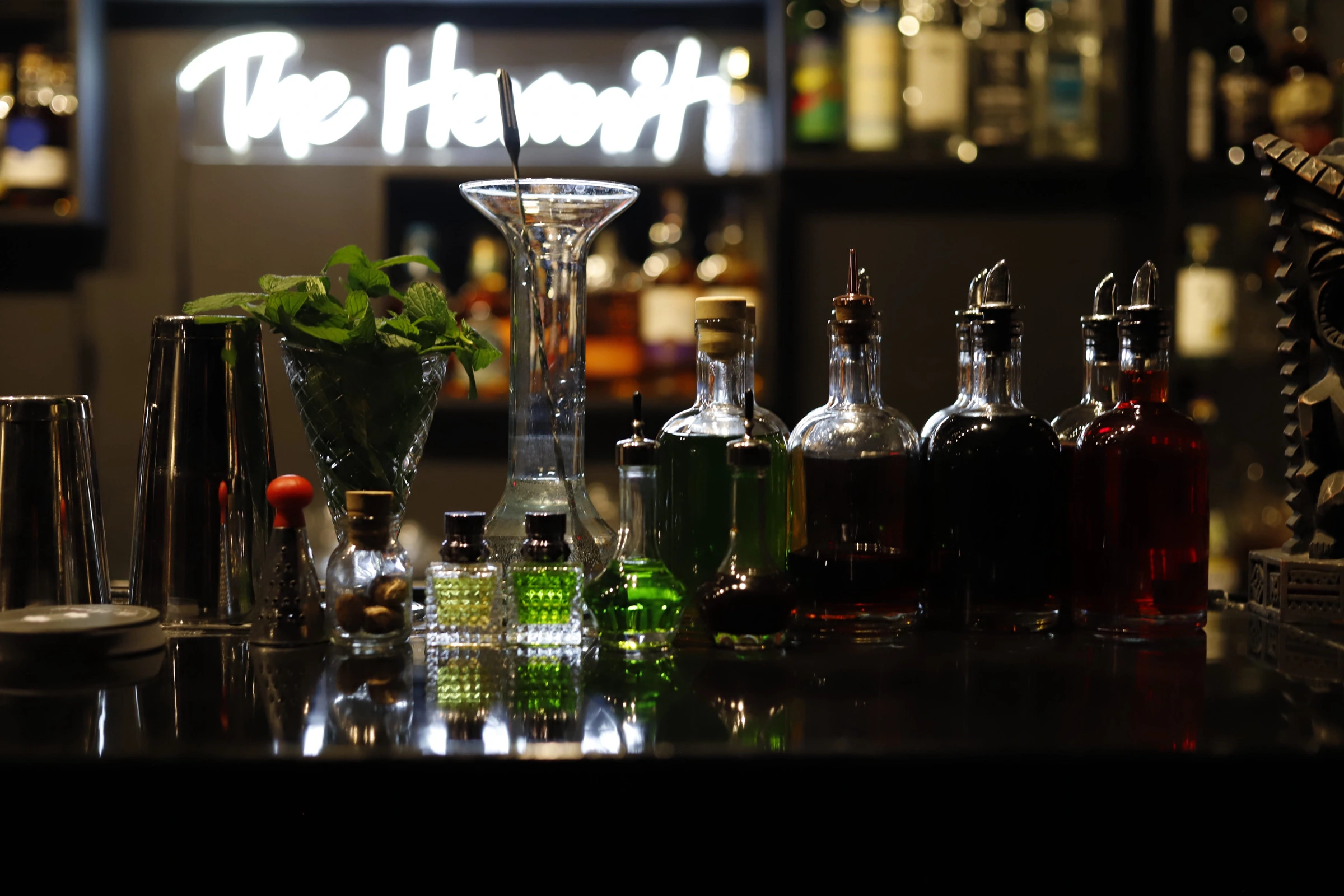 The Hermit Cocktail Bar dimly lit interior with ambient lighting, cocktail bar and premium spirits display